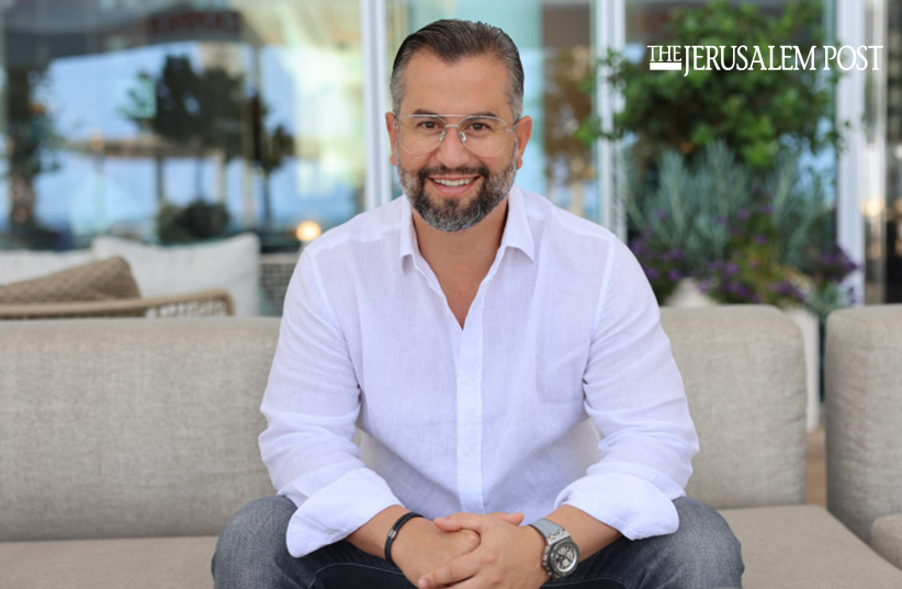 Eitan Neishlos on couch at Kempinski Hotel, Tel Aviv